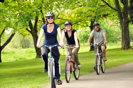 three people cycling in park