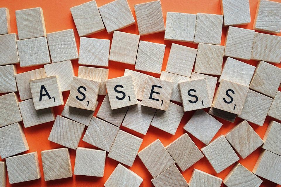 Scrabble tiles spelling the word assess
