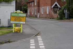 A sign by the side of a country road to announce forthcoming roadworks