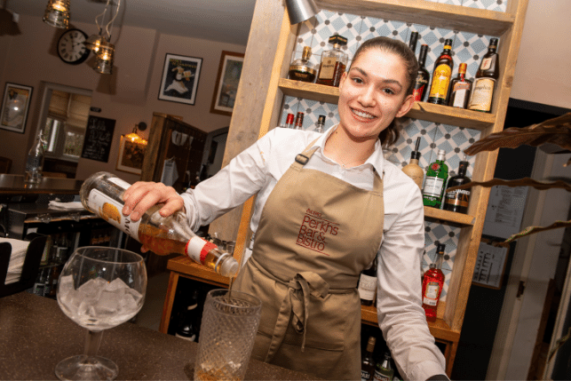 Member of staff pouring a drink at Perkins Bistro and Bar