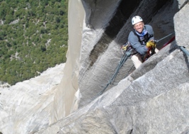 Phil Barker (man) climbing a rock