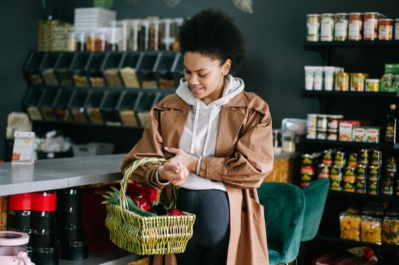 Woman with a basket of food in a shop