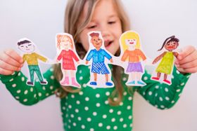 Child holding paperchain people 