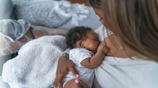 A woman cradling a new born baby