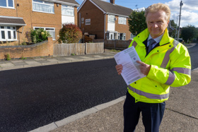 Councillor Neil Clarke MBE at Kirk Close in Chilwell with a letter