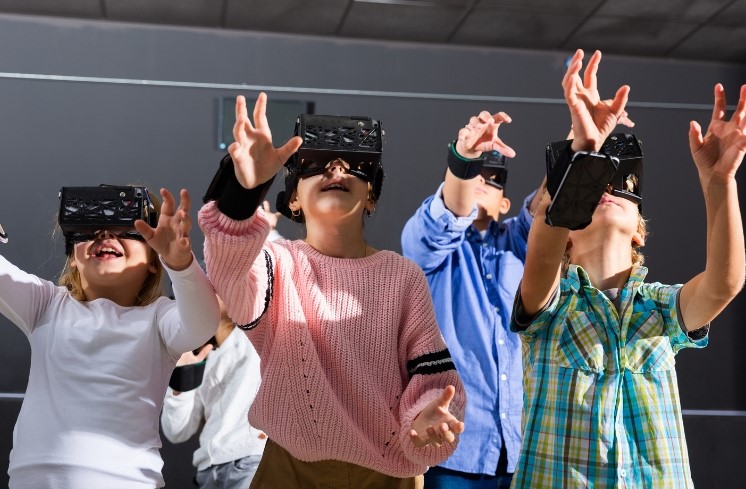 Children wearing virtual reality headsets
