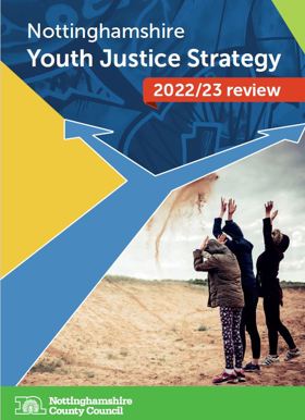 Picture of young people on a beach throwing sand. Text says Youth Justice Strategy 2022/23