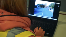 Young driver watching an instruction video on a computer screenfor driving course