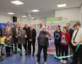 A ribbon being cut by a female at the reopening of a Young People's Centre.
