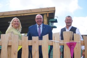 Left to right: Marina George, Family Hub Network Manager, Councillor Mick Barton Leader of Nottinghamshire County Council and Councillor Kevin Brown, Nottinghamshire County Councillor for the Mansfield South division stood on an outdoor apparatus at Mansfield family hub.