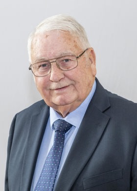 A photograph of Cllr Barry Answer. He is wearing glasses and a navy blue suit and tie.