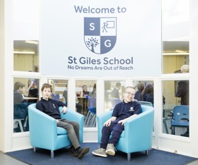Pupils Harry and John under St Giles school sign