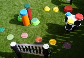 Colourful outdoor games laid on artificial grass.