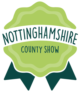 Logo for event. It is a rosette shape with a light green middle and dark green ribbons hanging down. It says Nottinghamshire County Show in the middle