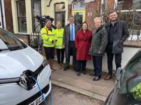 Emma Satchell and Jo Horton from Via East Midlands, Anthony Browne MP, Ruth Edwards MP, Cllr Neil Clarke MBE, and Ben Bradley MP stand beside an electric car which is charging with a blue cable