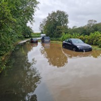 Image of cars stranded in the road due to flooding