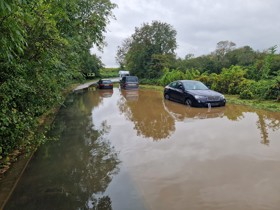 Image of cars stranded in the road due to flooding