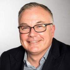 Guy Van Dichele smiling to the camera